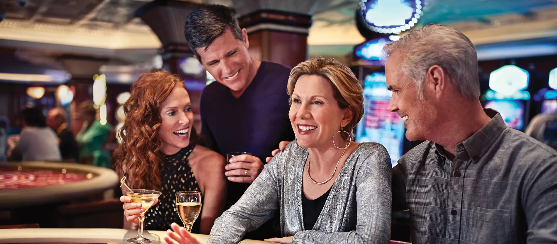 Friends enjoying drinks and socializing in a casino with slot machines
