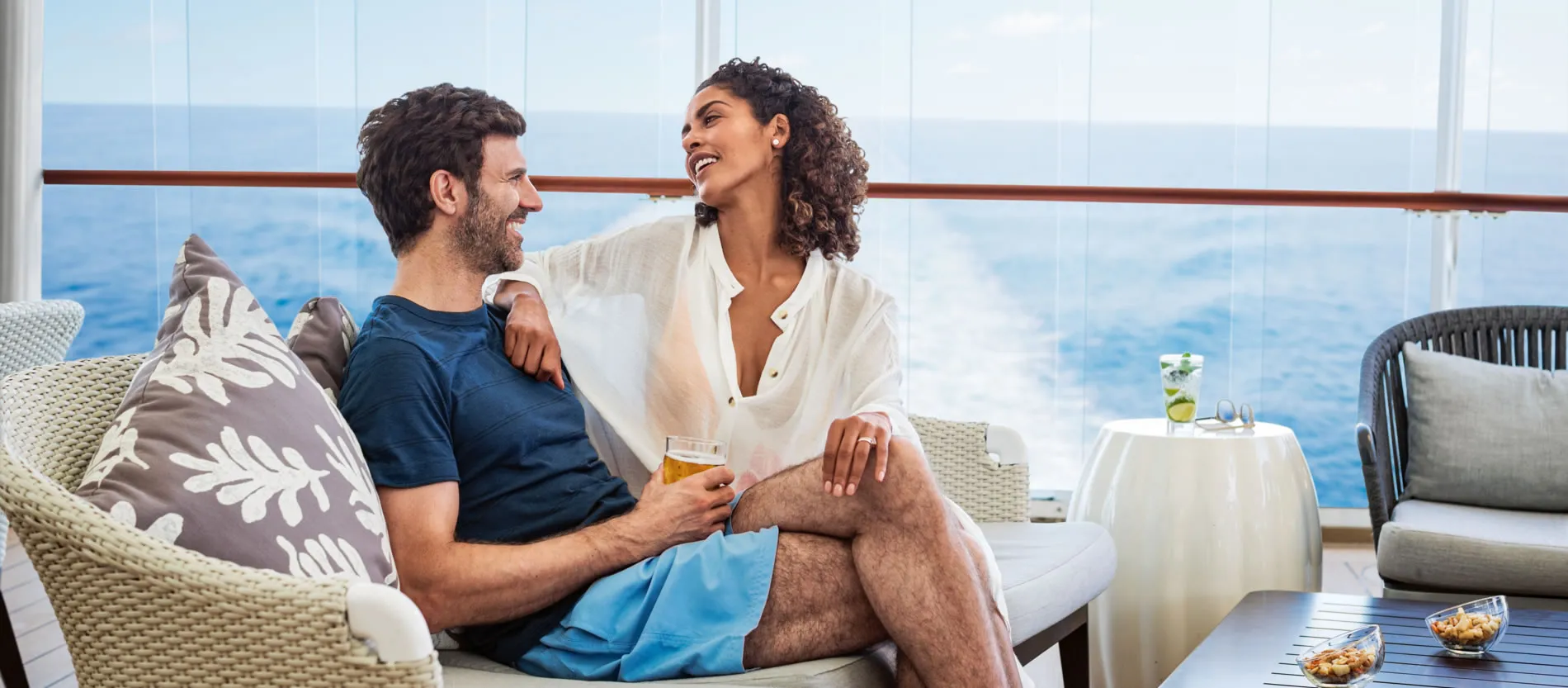 Couple relaxing together on cruise ship balcony with ocean view