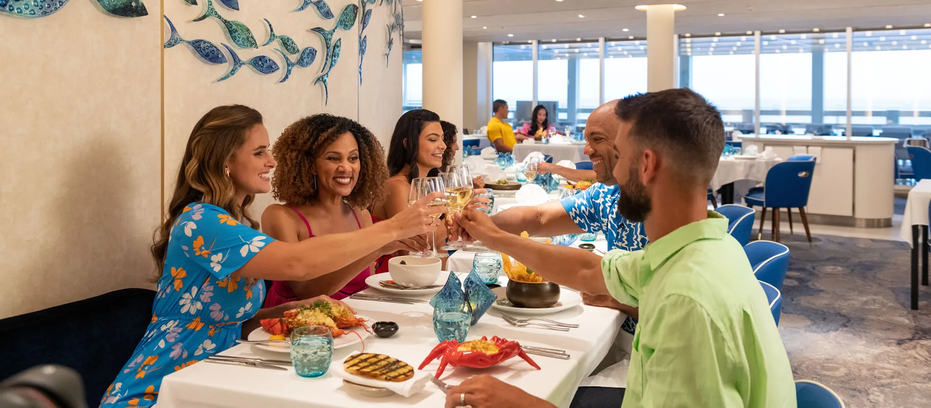 Friends toasting and enjoying a meal together in a bright restaurant