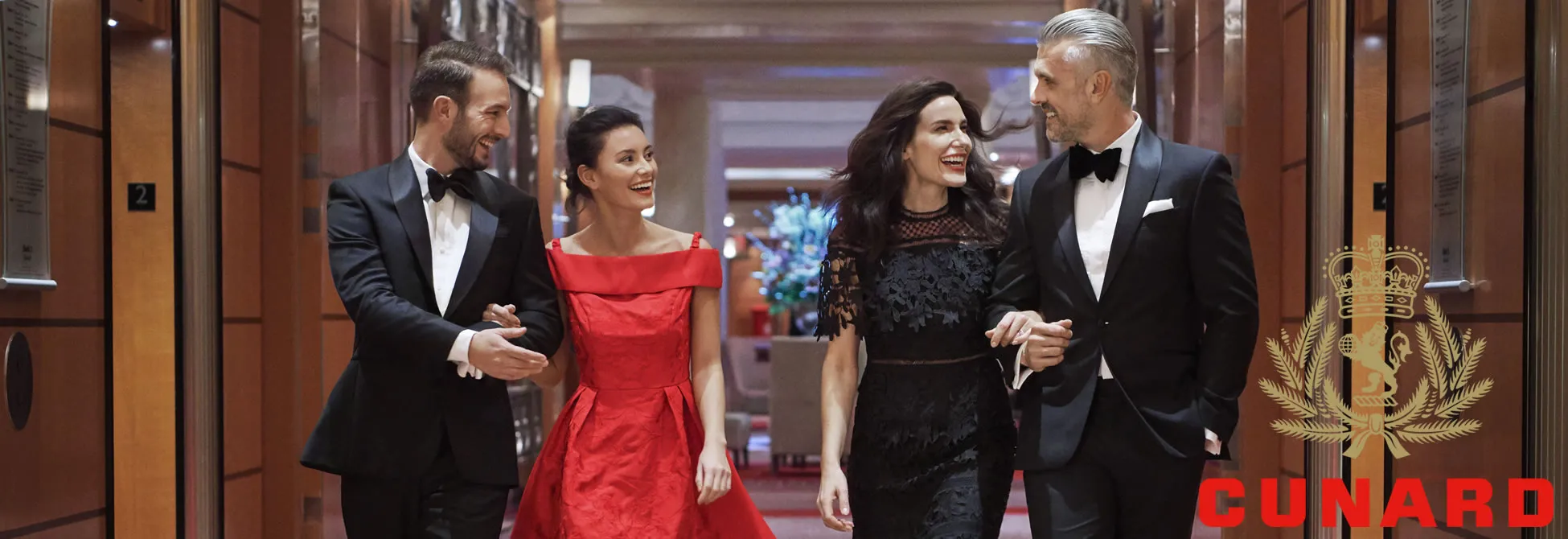 Elegant couples in formal attire walking together on a luxury cruise ship