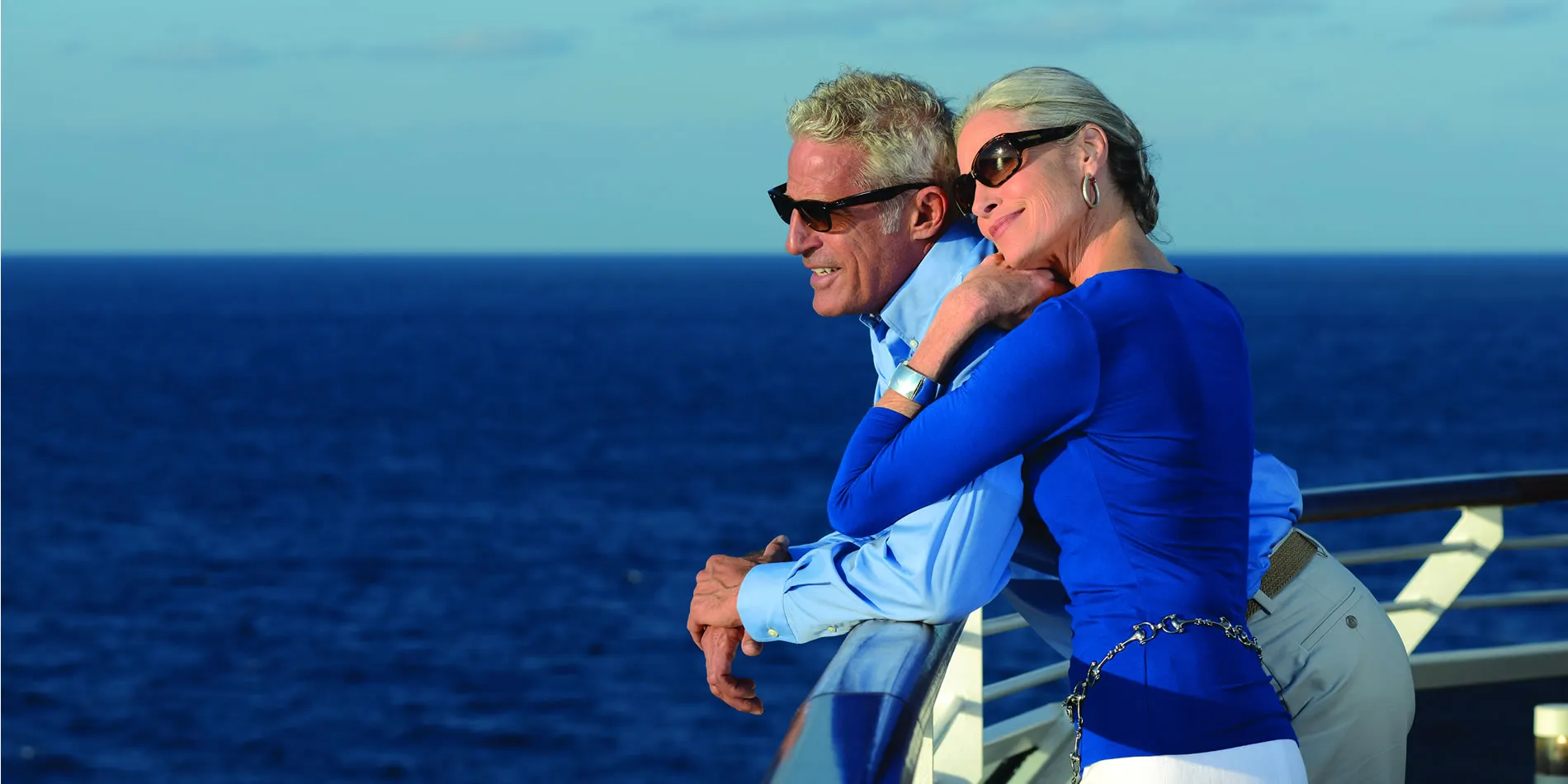 Mature couple enjoying ocean view from cruise ship deck