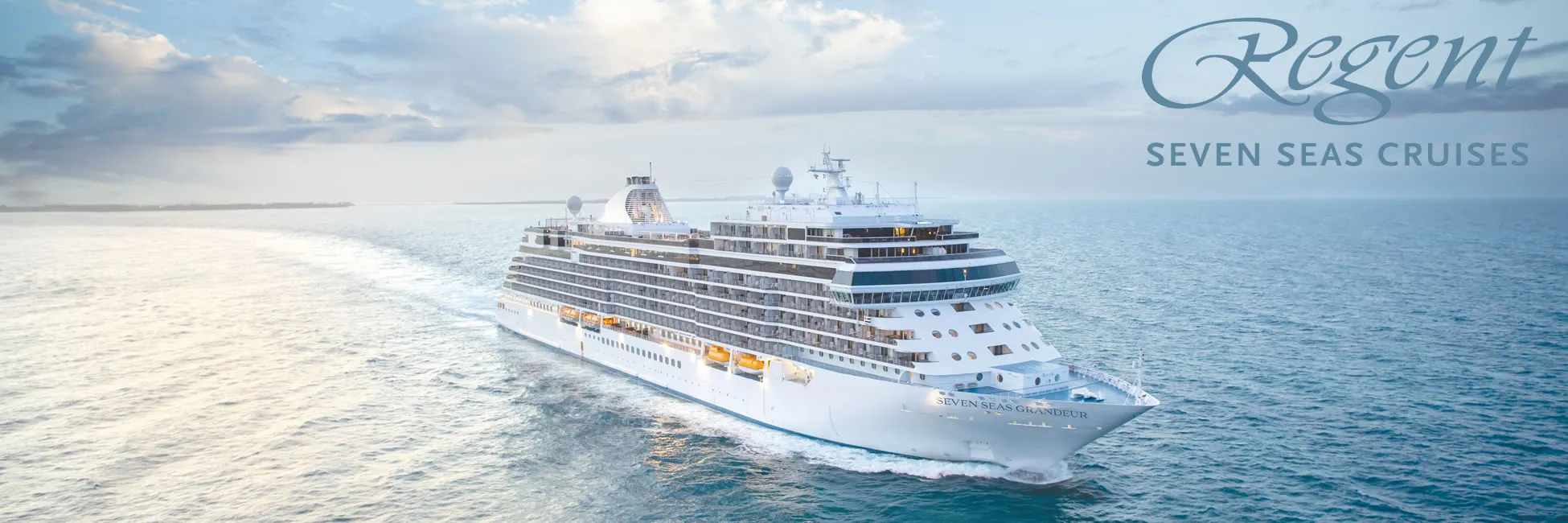 Regent Seven Seas cruise ship sailing on calm blue ocean waters