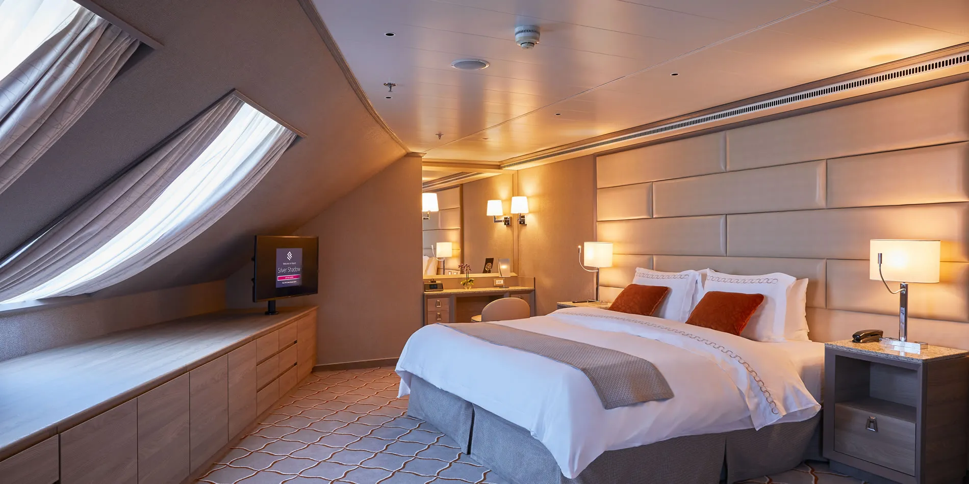 Luxurious cruise ship cabin with warm lighting and elegant design