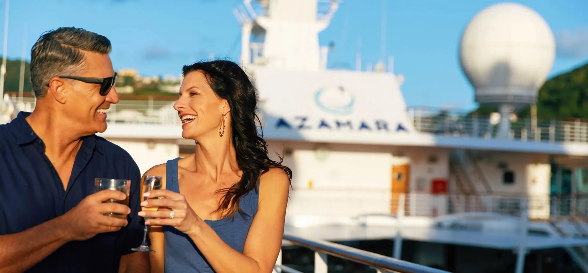 Couple enjoying drinks on an Azamara cruise ship deck