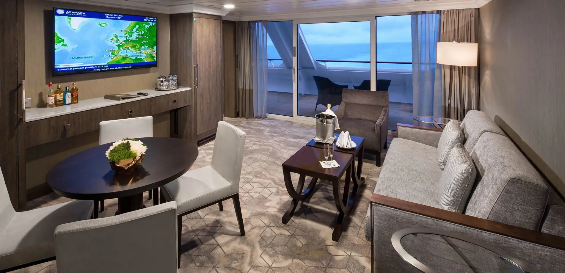 Luxury cruise ship suite with ocean view, bar, and champagne