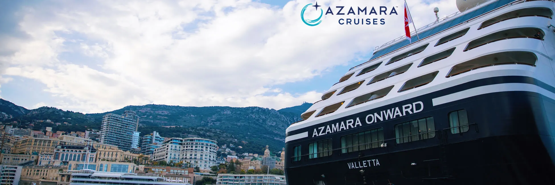 Azamara Onward cruise ship docked in coastal Mediterranean city with mountains