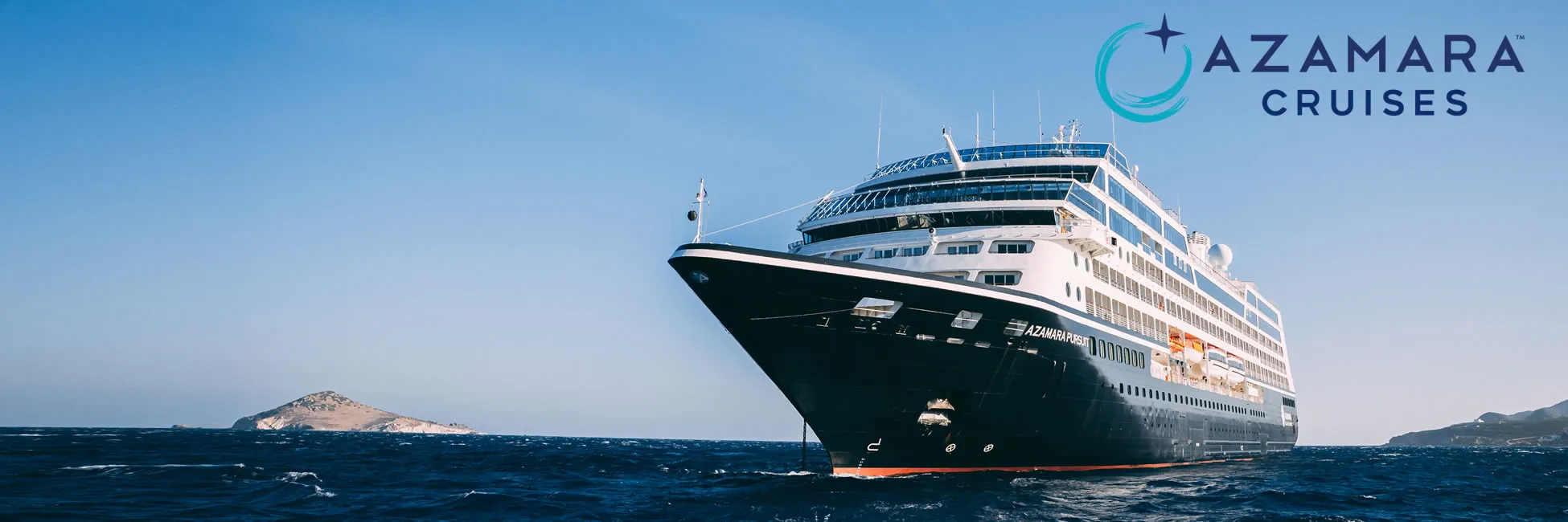 Azamara Cruises ship sailing on blue ocean near rocky coastline