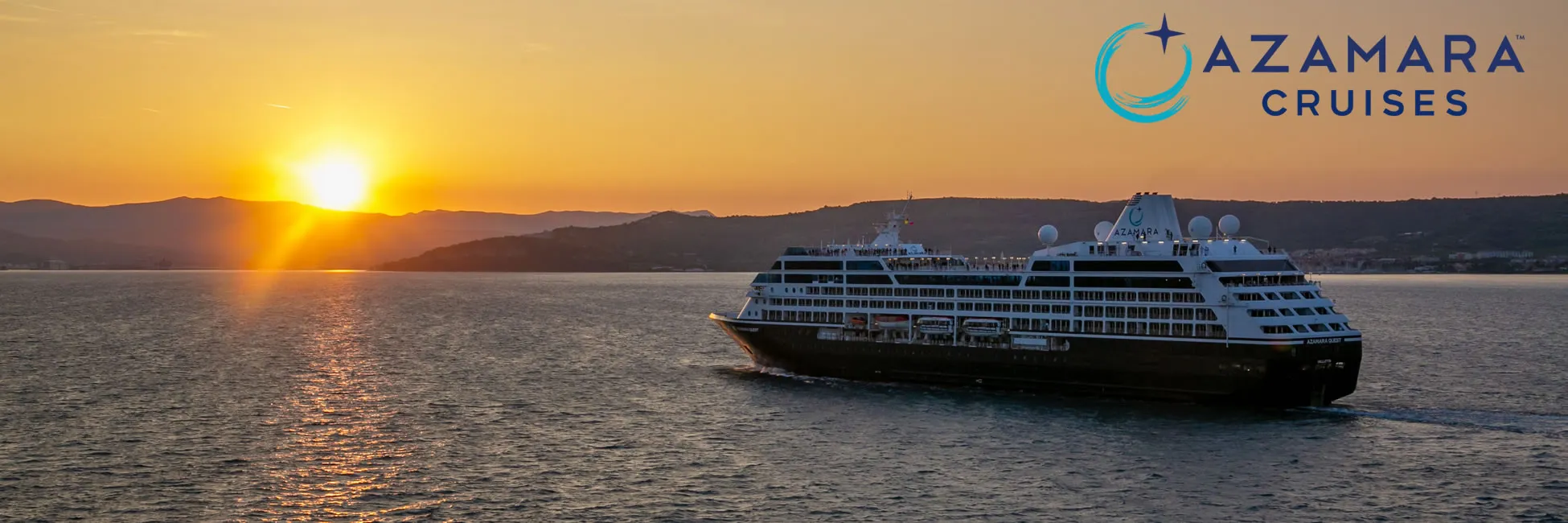 Azamara cruise ship sailing at sunset with mountains in background