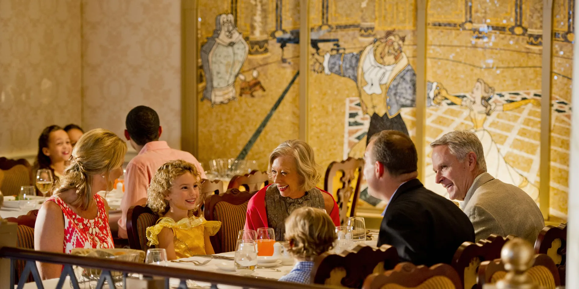 Families dining together in elegant restaurant with decorative yellow wall art