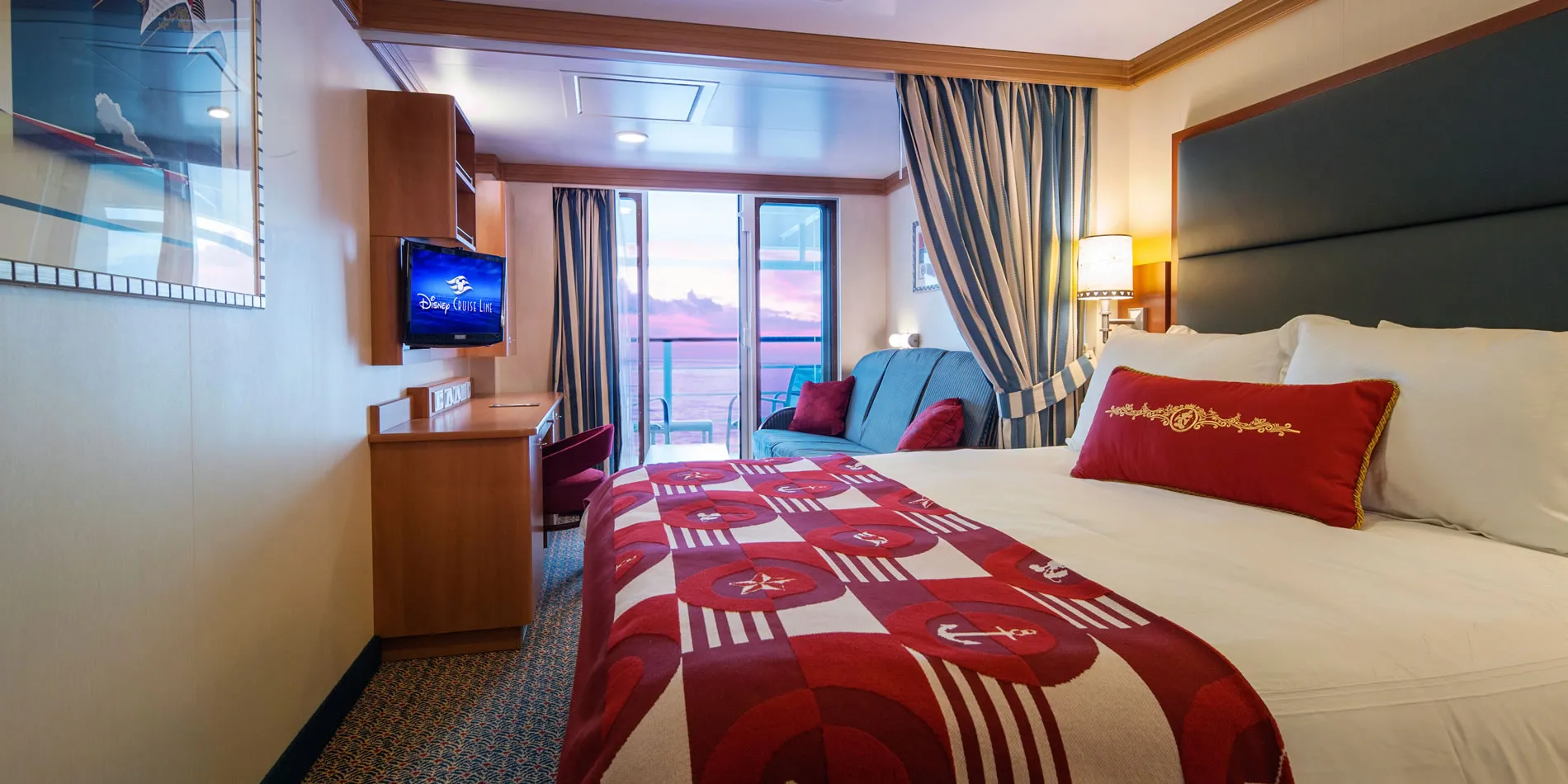 Disney Cruise Line stateroom with balcony and ocean sunset view