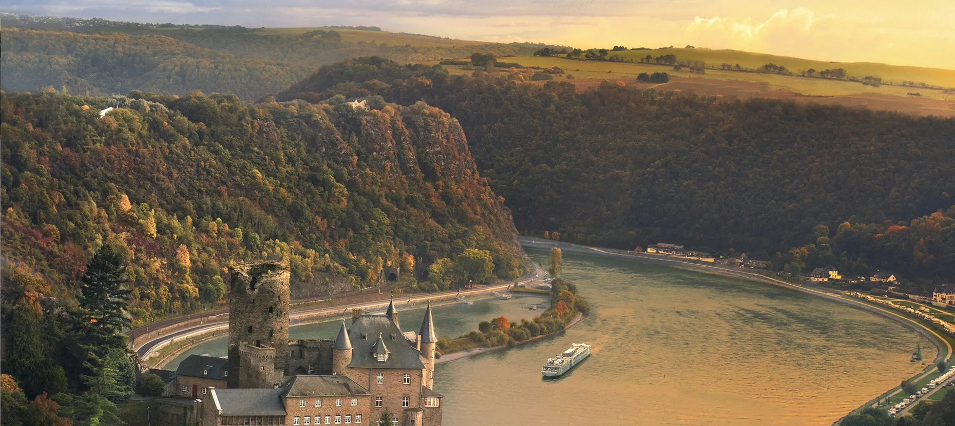 Scenic Rhine River valley with medieval castle and autumn-colored forests