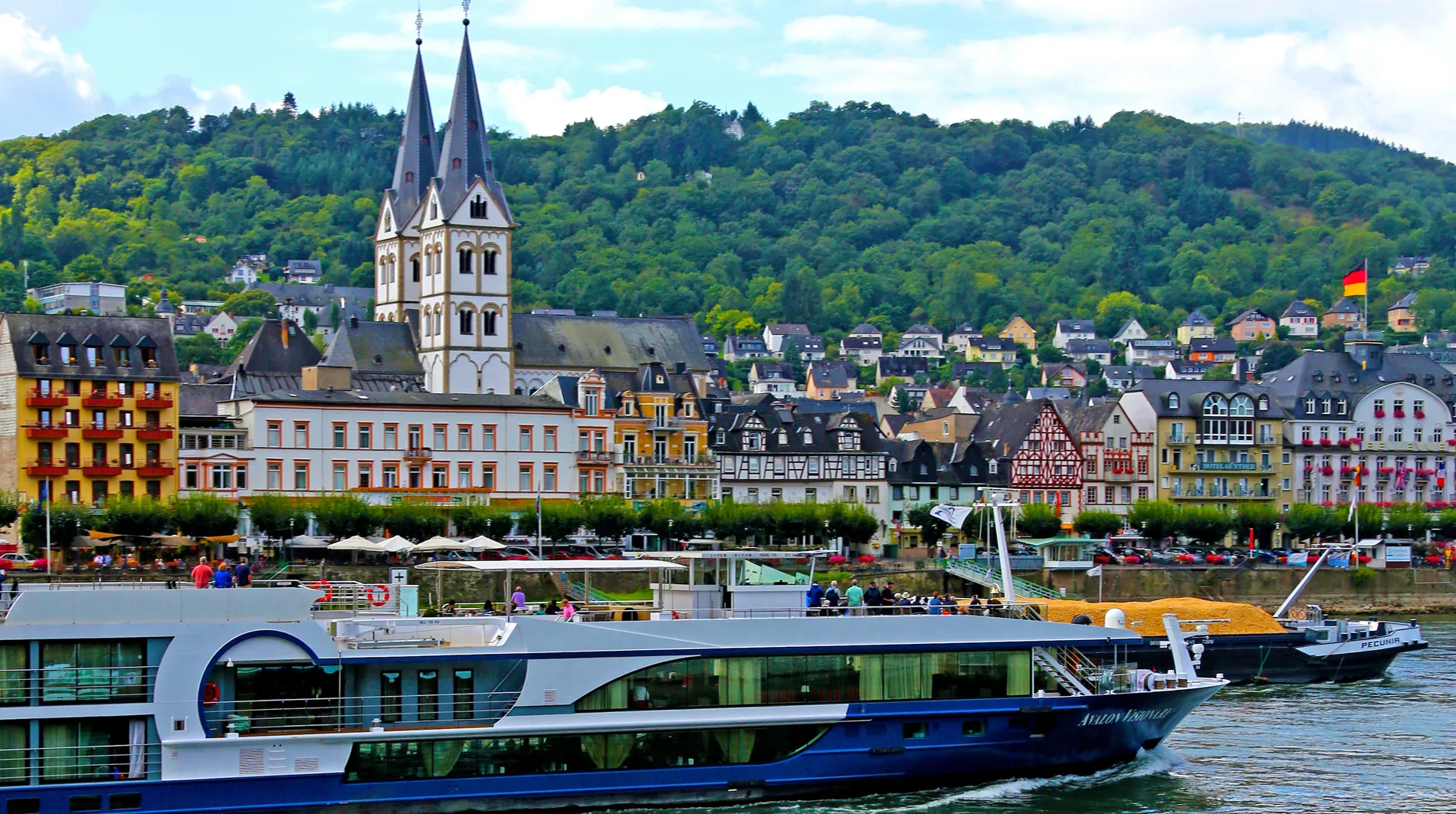 River cruise boat docked in charming German riverside town with historic buildings