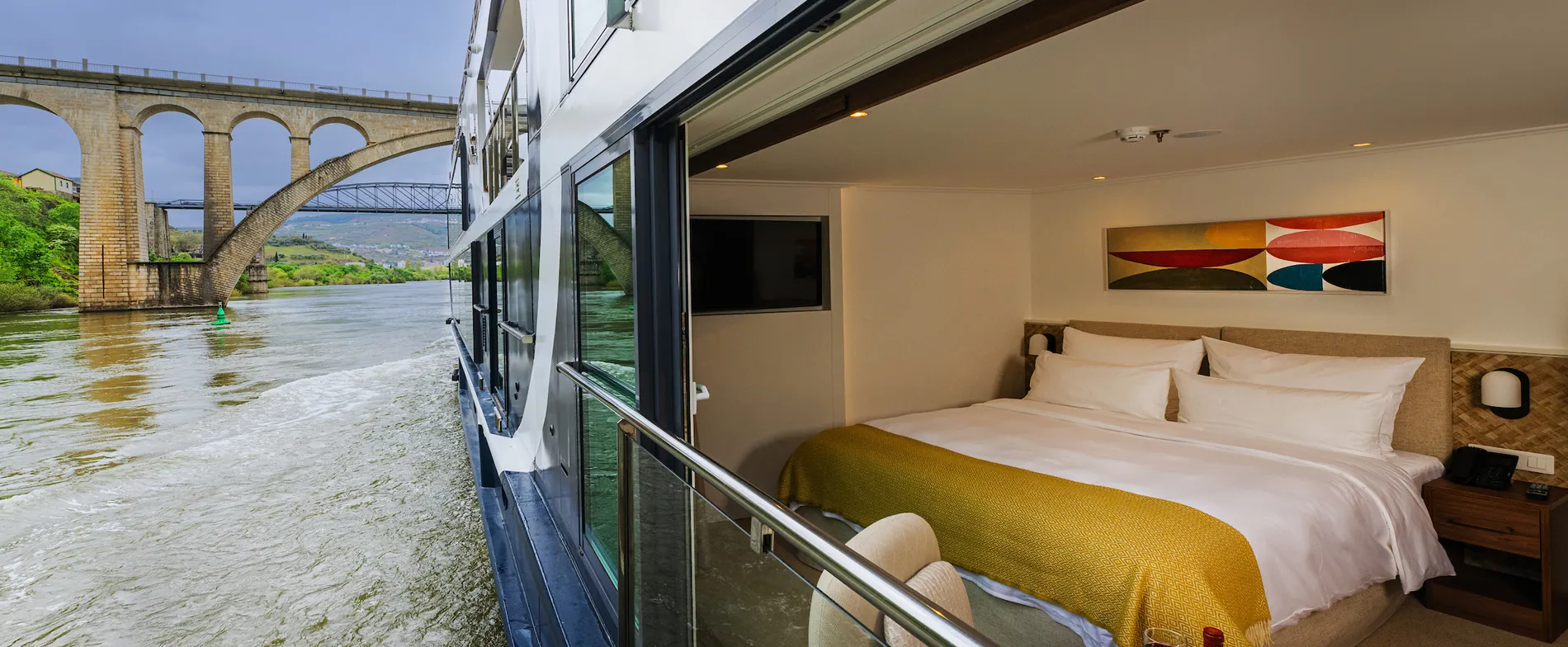 River cruise cabin with stone bridge view and modern interior design