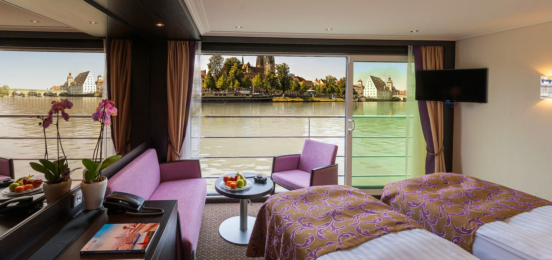 Luxury river cruise cabin with panoramic view of historic European city