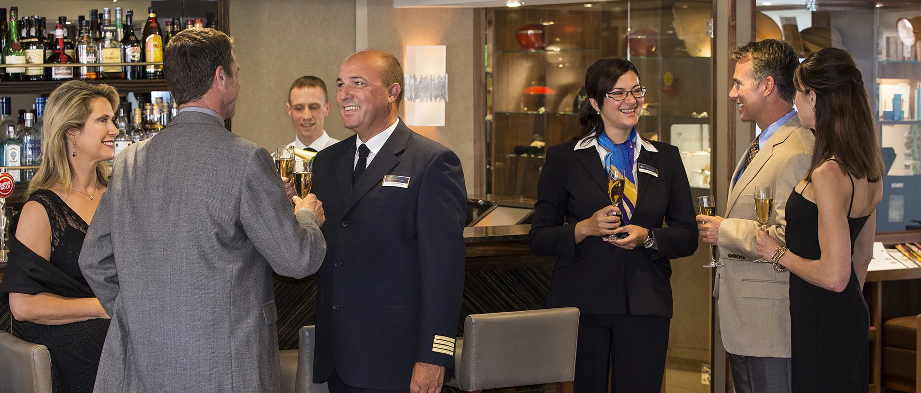 Hotel staff socializing and drinking champagne at a bar