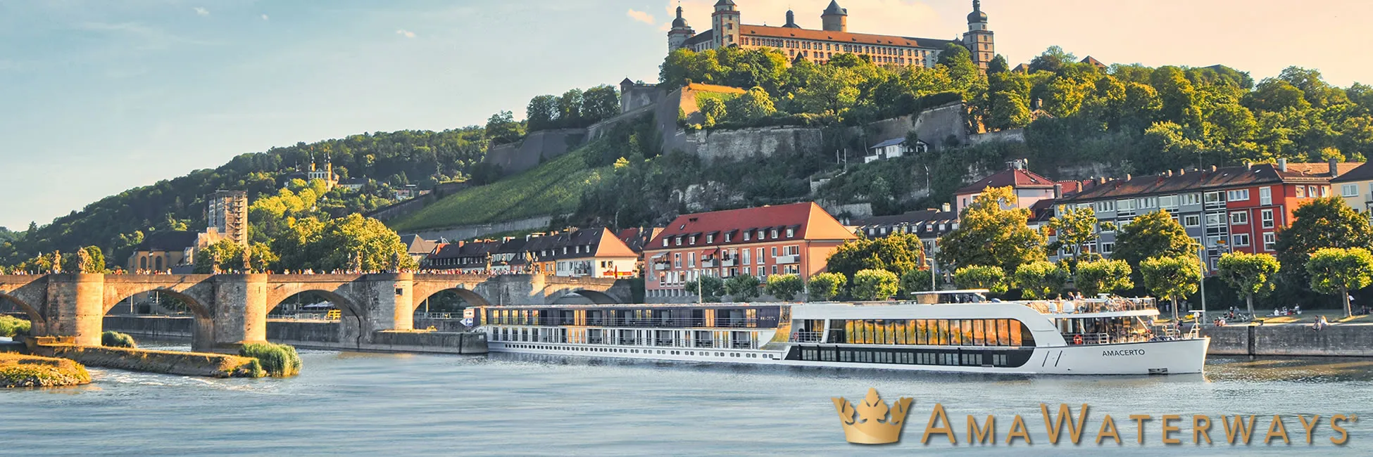 River cruise ship passing historic fortress and bridge in European city
