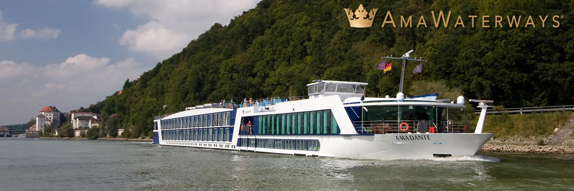 AmaWaterways river cruise ship Amadante sailing along forested riverbank
