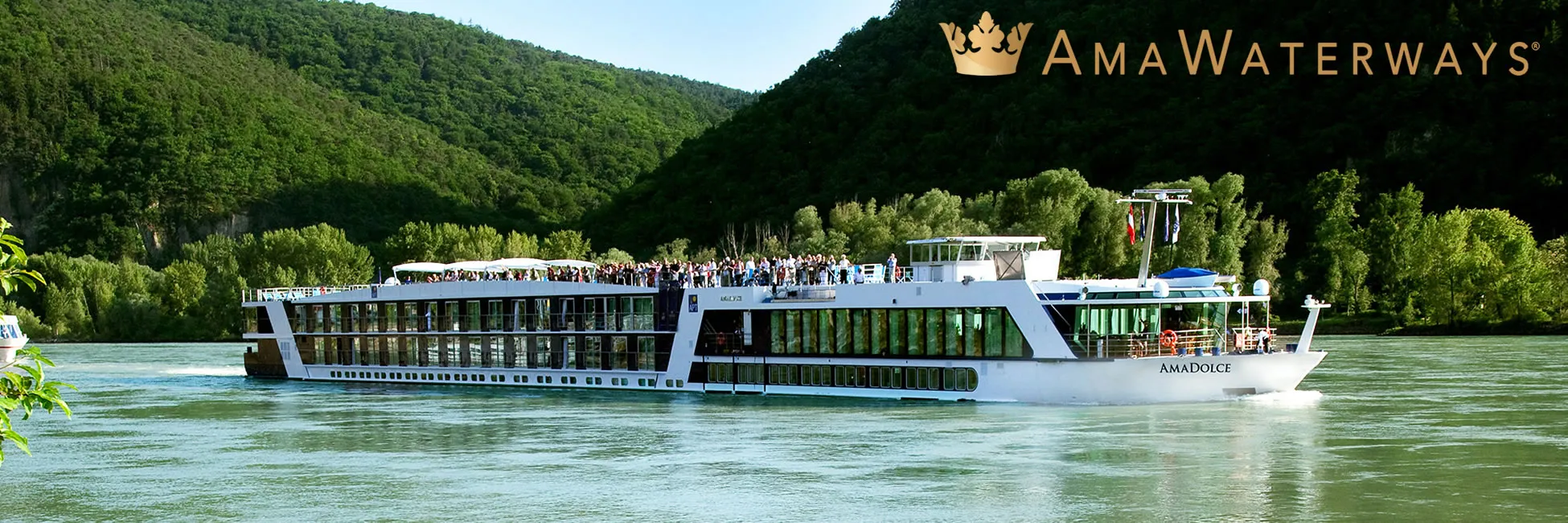 AmaWaterways river cruise ship sailing through lush green landscape