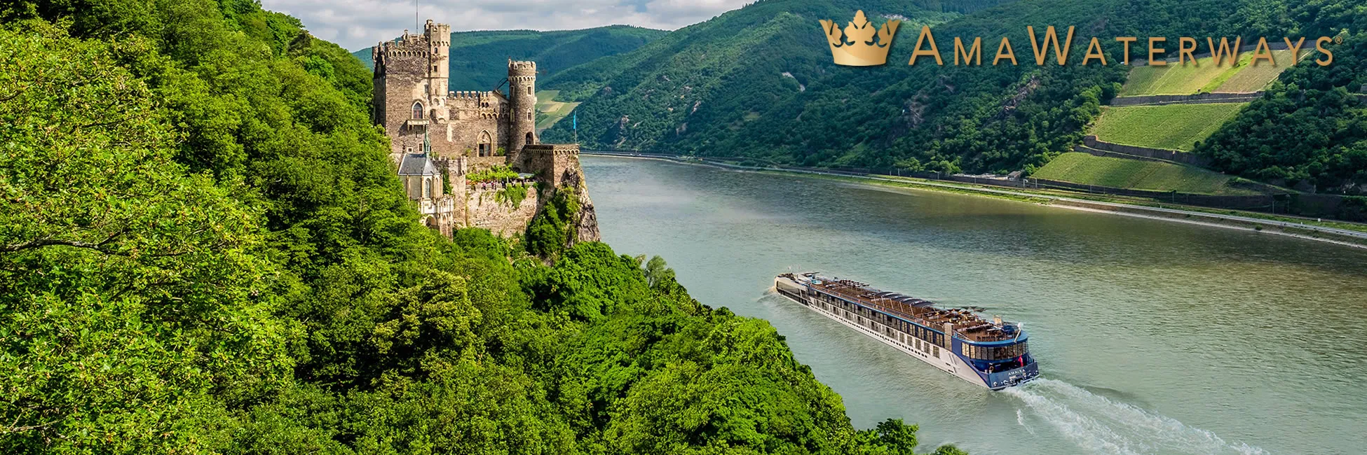 River cruise ship passing medieval castle along lush Rhine Valley landscape