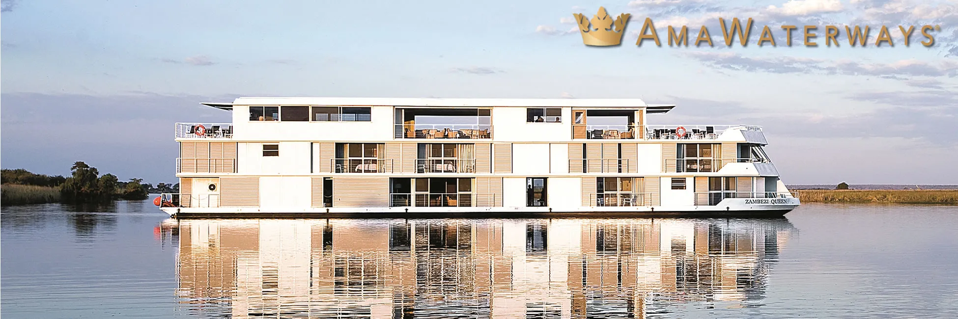 AmaWaterways river cruise ship reflecting on calm water at sunset