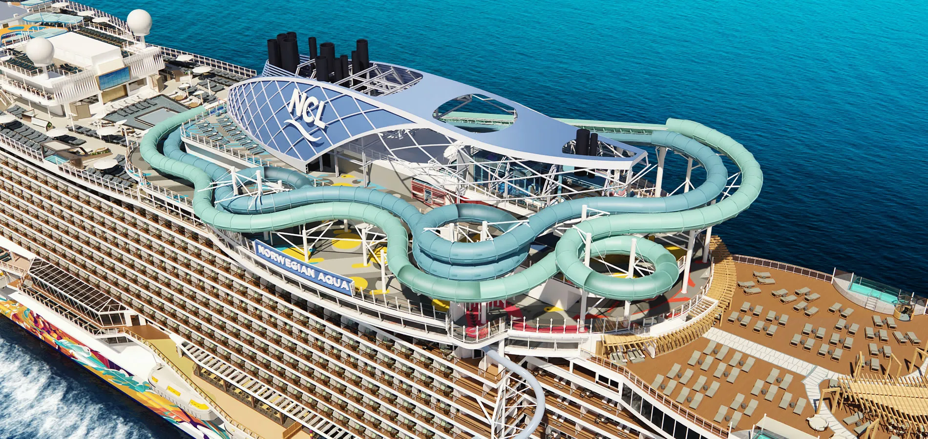Norwegian Cruise Line ship with complex water slides on blue ocean