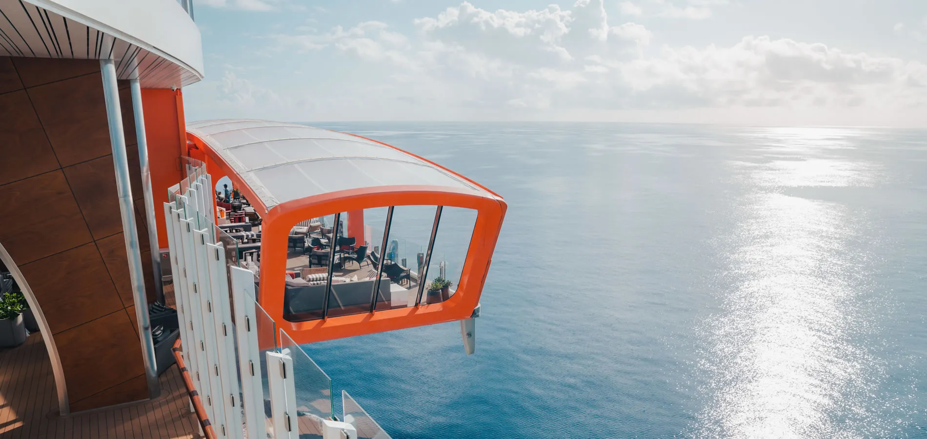 Orange observation deck extending over cruise ship with ocean view