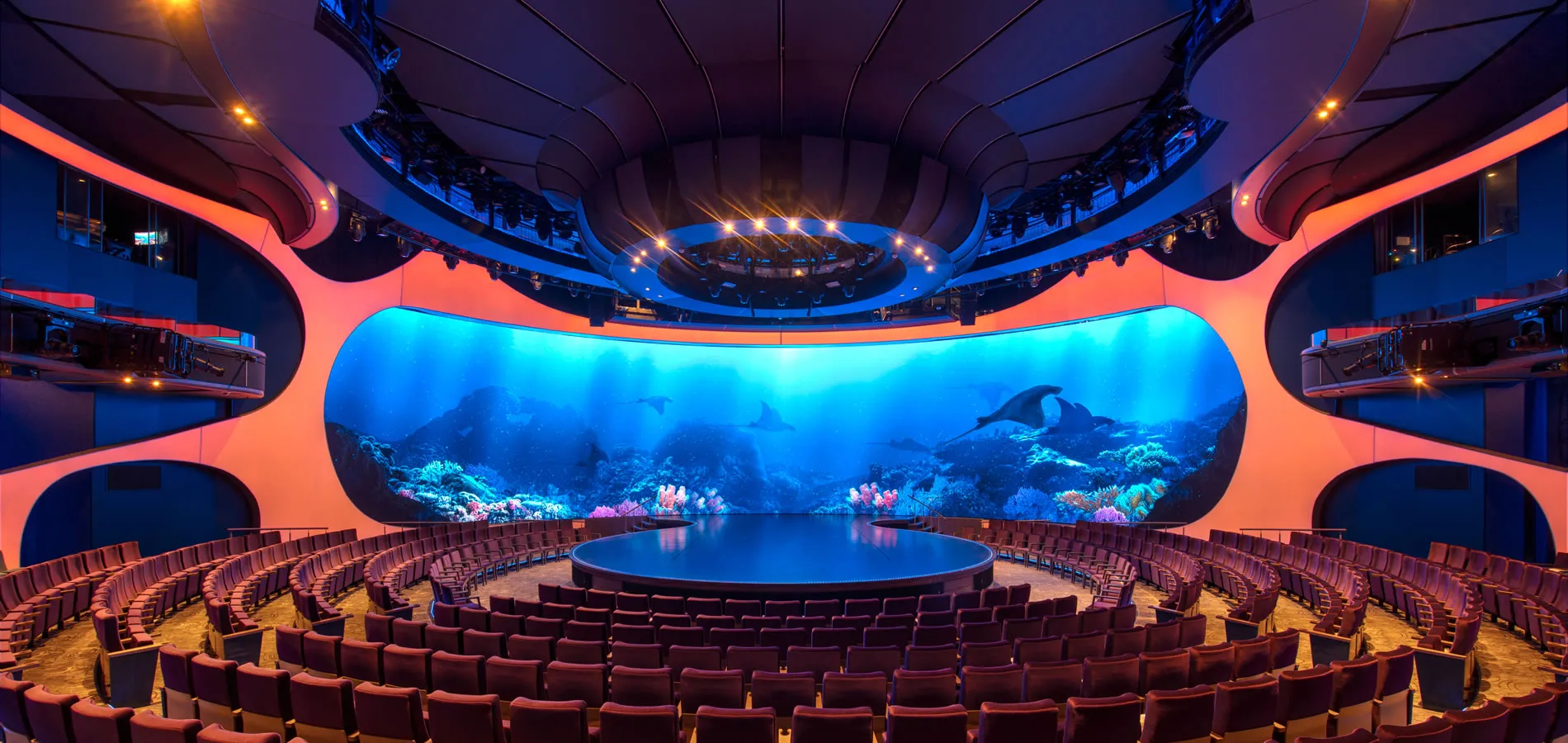 Futuristic theater with immersive underwater scene on curved blue screen