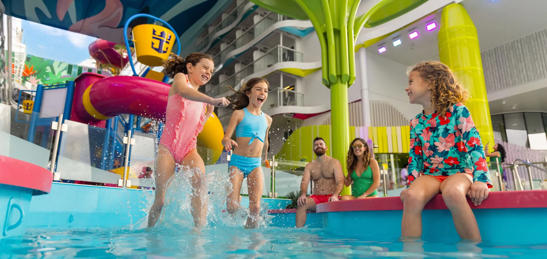 Children splashing and having fun in a colorful indoor water park