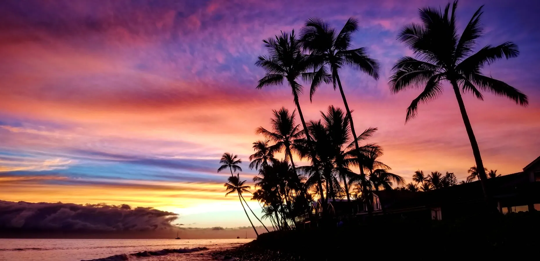 Vibrant sunset with palm trees silhouetted against colorful tropical sky