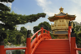 Golden pavilion with red bridge in traditional Chinese garden landscape