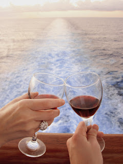 Two wine glasses toasting with ocean view from boat or ship deck