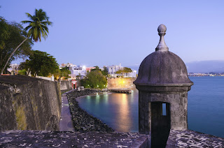 Historic stone watchtower overlooking calm blue water at Old San Juan fortress