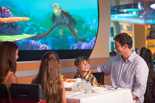 Family watching sea turtle documentary at restaurant or museum exhibit