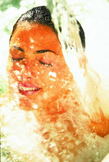 Artistic portrait of a person with orange and white watercolor effect