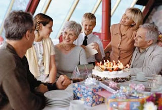 Seniors celebrate birthday with cake and candles at a festive gathering