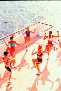 Athletes training on deck of boat with colorful workout outfits