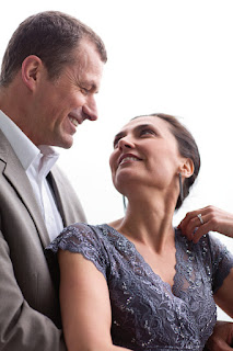 Smiling middle-aged couple looking affectionately at each other in formal attire