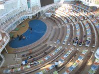 Circular conference hall with tiered seating and a blue central floor