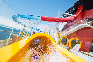 Colorful water slides on a cruise ship deck splashing with excitement