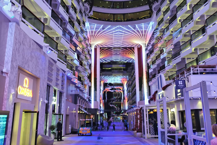 Futuristic mall interior with colorful geometric light canopy and modern architecture