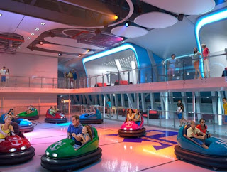 Colorful bumper cars on vibrant floor inside modern indoor entertainment space