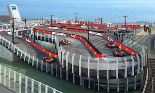 Racing cars navigate winding track on multilevel elevated concrete circuit