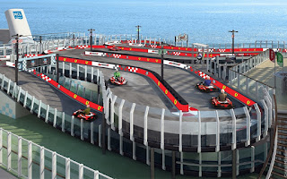 Go-kart track with red tracks overlooking ocean and pier
