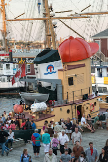 Historic ships and crowds gather at maritime festival or harbor event