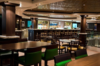 Modern bar and lounge interior with stylish seating and decorative ceiling