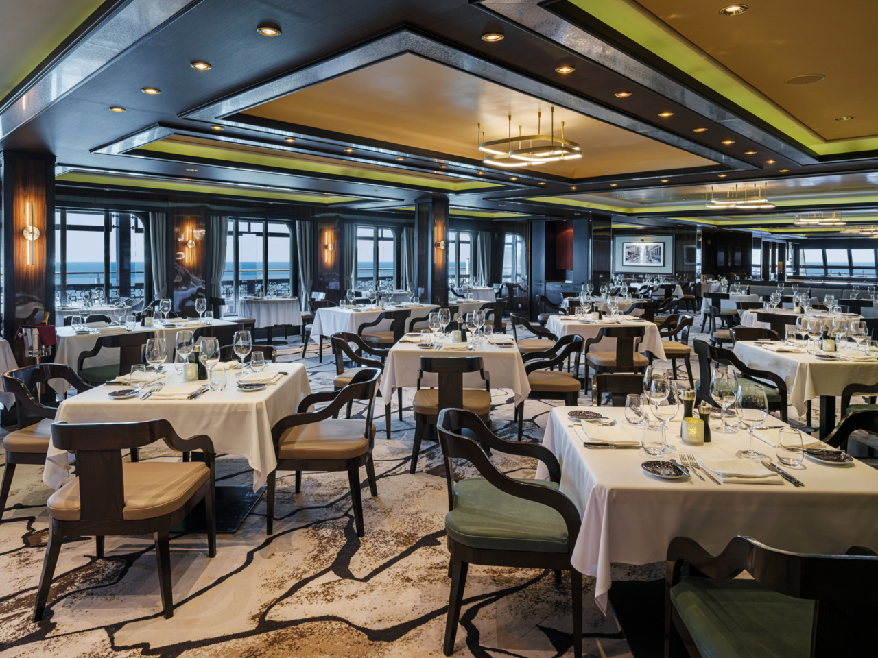 Elegant dining setup at Cagneys Steakhouse aboard Norwegian Breakaway with refined plating and upscale ambiance.