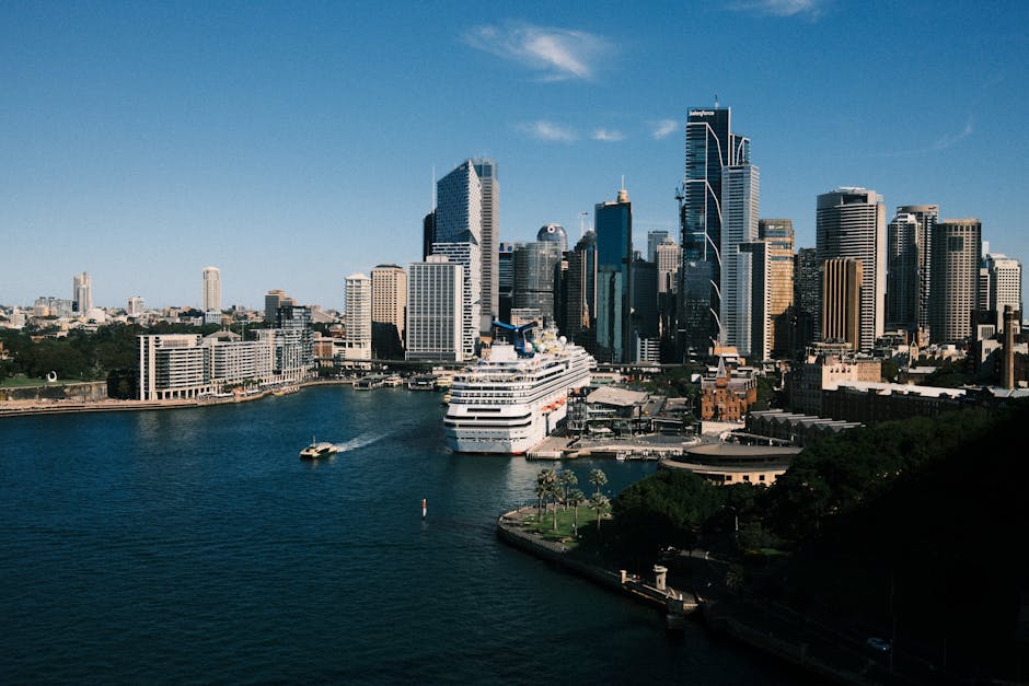 Stunning view of Sydney skyline and cruise ship docked at the harbor during day.