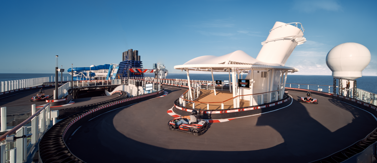 Electric go-kart racers navigate the two-level Speedway track wrapping around Norwegian Encore's funnel on the upper deck.