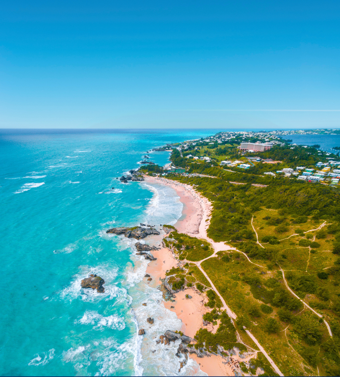 Aerial drone view of Horseshoe Bay Beach in Bermuda showing pink sand crescent and turquoise waters