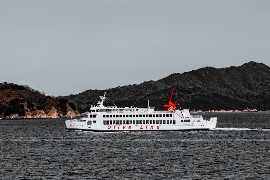An Olive Line ferry cruising through the Seto Inland Sea near Shodoshima island, Japan, with calm waters and the island landscape visible — capturing the scenic coastal passages typical of a Japan circle cruise itinerary.